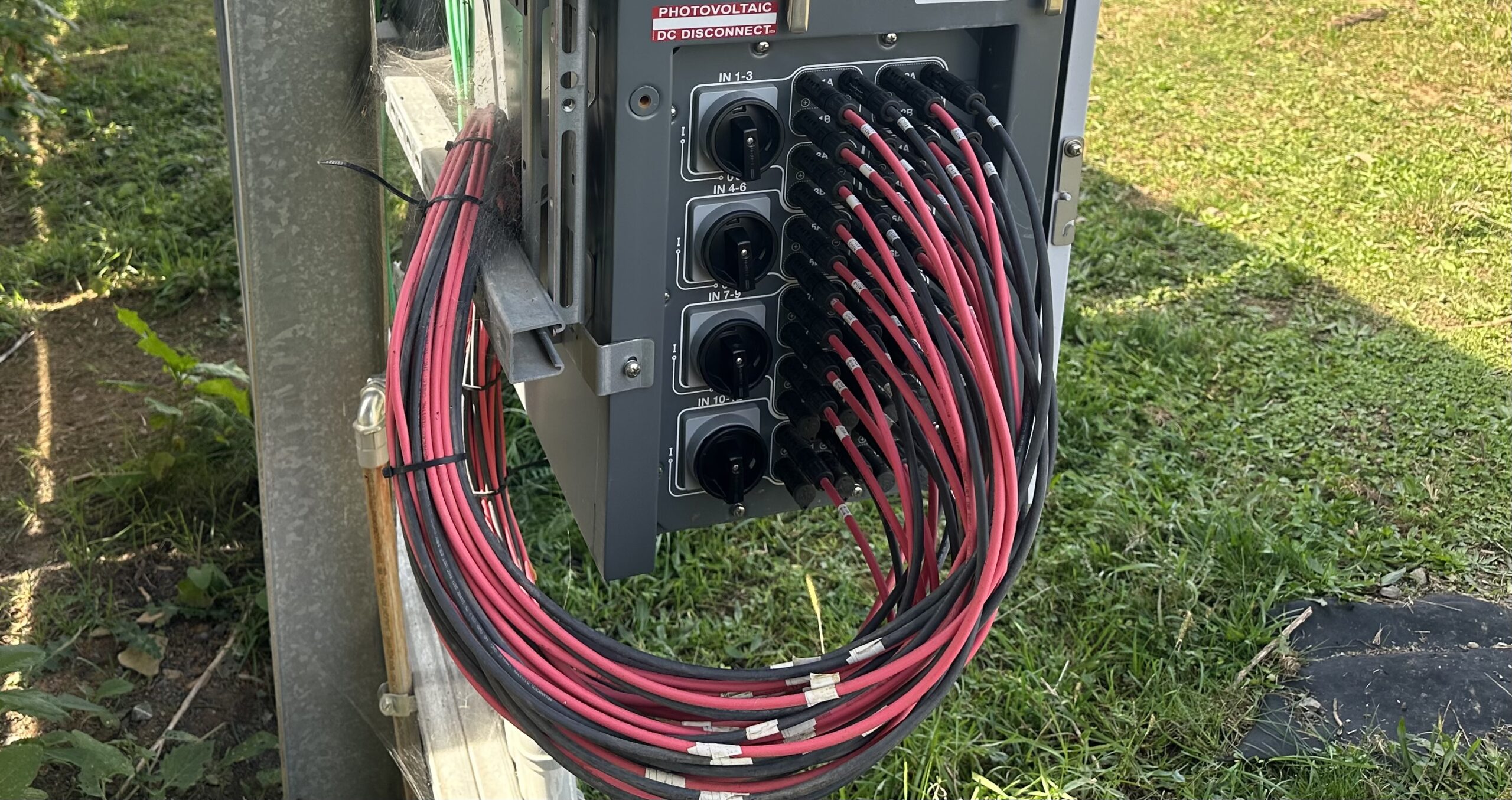 Red and black PV wire attached to an inverter